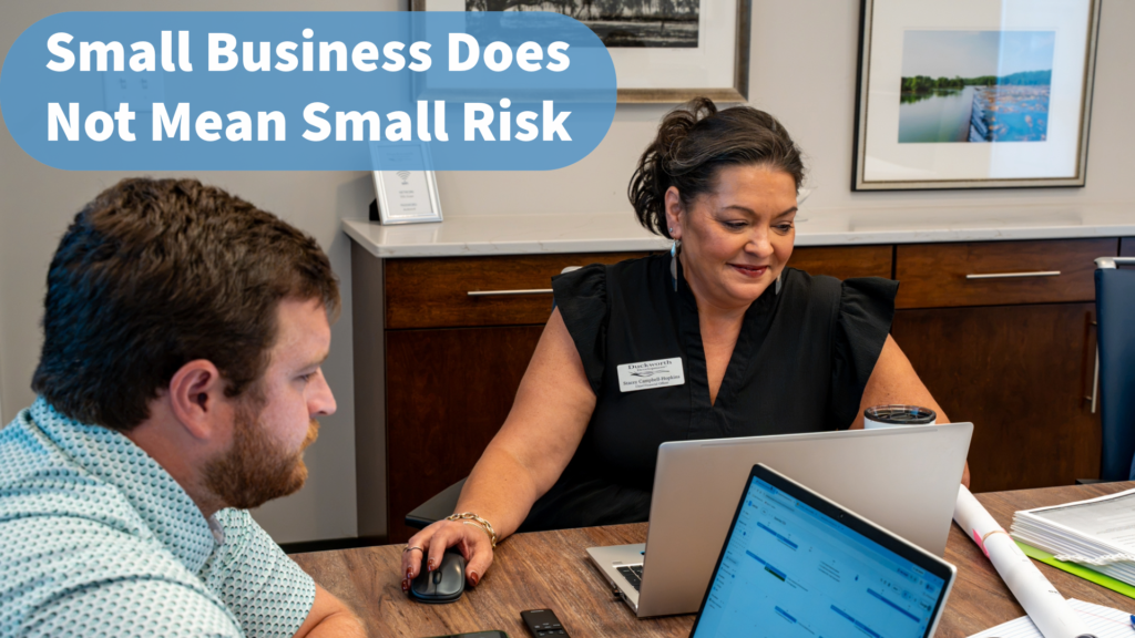 Small business owner discussing IT and small business cybersecurity protection with employees